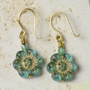 A pair of earrings made from blue glass flower beads.