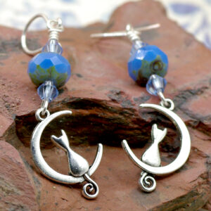Earrings with blue glass beads and pretty kitties on crescent moons.