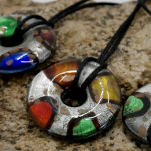 A glass donut bead in funky colors on a black silk cord chain.