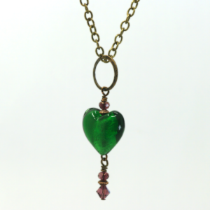 A necklace with a large, green glass heart.