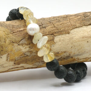 A stretch bracelet made with lava rock, citrine and pearl beads.