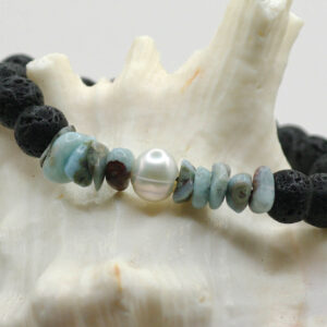 A stretch bracelet made from black lava rock, blue larimar and freshwater pearl beads.